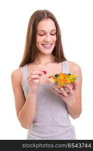 Jelly gummy bears! I love them!. Young woman holding a bowl of jelly gummy bears, isolated over white background