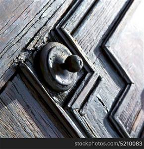 jerago varese abstract rusty brass brown knocker in a door curch closed wood lombardy italy