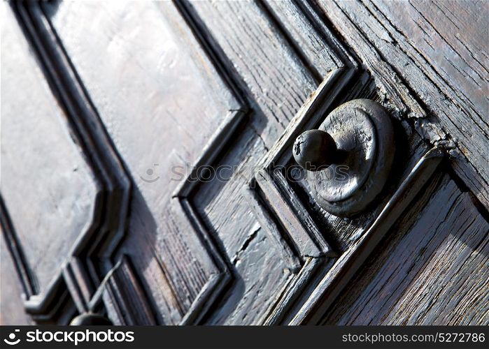 jerago varese abstract rusty brass brown knocker in a door curch closed wood lombardy italy