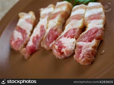 Jerked meat .uncooked dried pork belly sliced