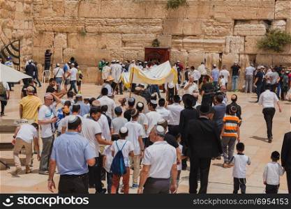 Jerusalem, Israel - May 9, 2016: Jewish worshipers gather for a Bar Mitzvah ritual at the Western wall in Jerusalem.