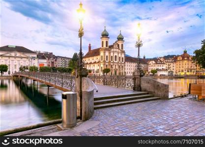 Jesuit Church and bridge over the river Reuss at sunrise in Old Town of Lucerne, Switzerland. Lucerne at sunrise, Switzerland