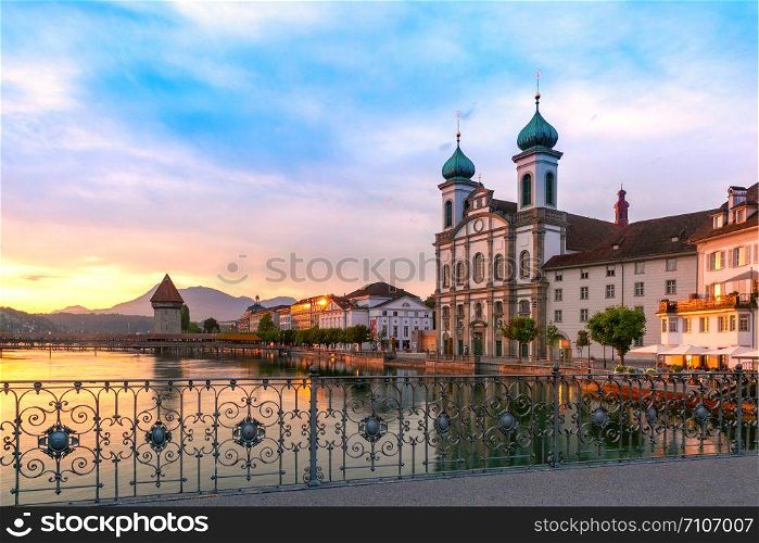 Jesuit Church and fairy tale houses along the river Reuss at sunrise in Old Town of Lucerne, Switzerland. Lucerne at sunrise, Switzerland