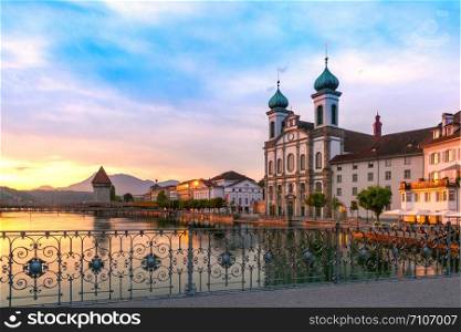 Jesuit Church and fairy tale houses along the river Reuss at sunrise in Old Town of Lucerne, Switzerland. Lucerne at sunrise, Switzerland