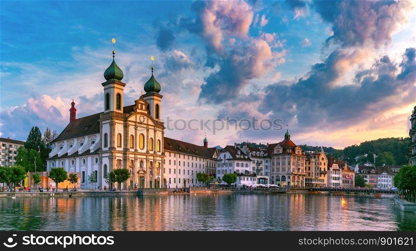Jesuit Church and fairy tale houses over the river Reuss at sunset in Old Town of Lucerne, Switzerland. Lucerne at sunset, Switzerland
