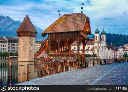 Jesuit Church, Water Tower, Wasserturm, and Chapel Bridge, Kapellbrucke, over the river Reuss in Old Town of Lucerne, Switzerland. Lucerne in the morning, Switzerland