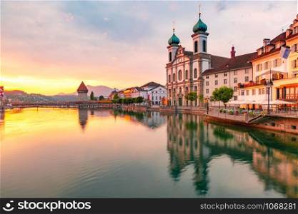 Jesuit Church, Water Tower, Wasserturm and the river Reuss at sunrise in Old Town of Lucerne, Switzerland. Lucerne at sunrise, Switzerland