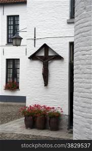jesus on the cross on a white wall in Oudenaarde in belgium