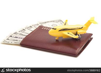 Jet plane and passport with dollars isolated on white