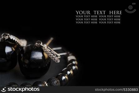 jewel handmade bracelet with semipreciouse stones and earrings with black semiprecious gem jet and fianitat black background