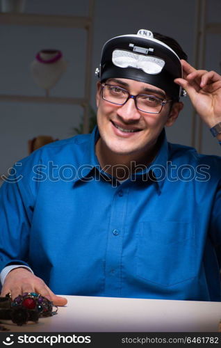 Jeweler working in his workshop late at night