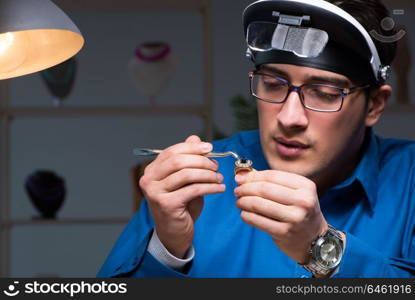 Jeweler working in his workshop late at night