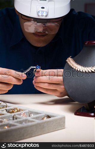 Jeweler working in his workshop late at night