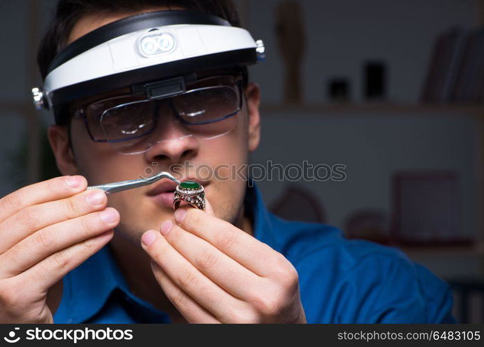 Jeweler working in his workshop late at night