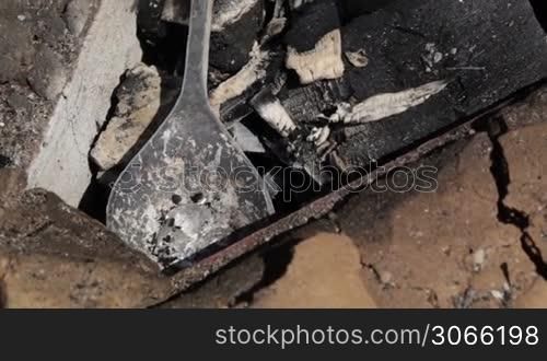 Jeweller is melting tin in a spoon. Clip 1