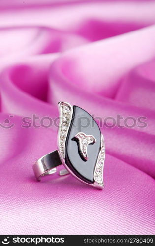 Jewellery ring on the satin background