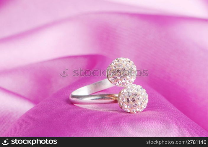 Jewellery ring on the satin background