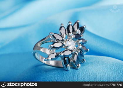 Jewellery ring on the satin background