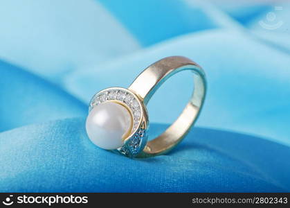 Jewellery ring on the satin background