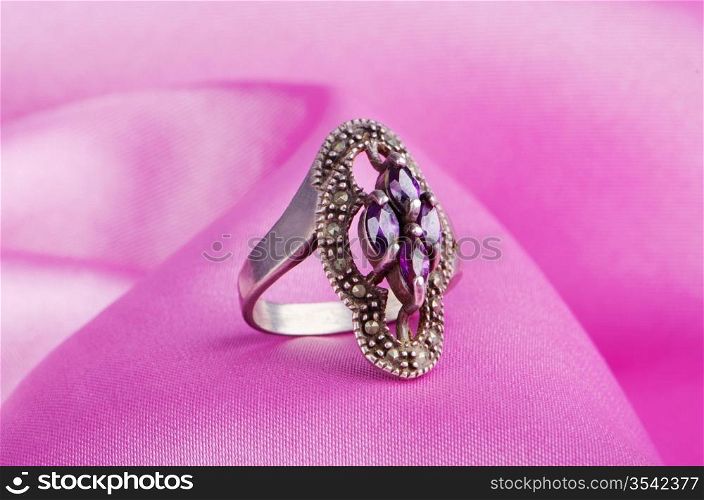 Jewellery ring on the satin background