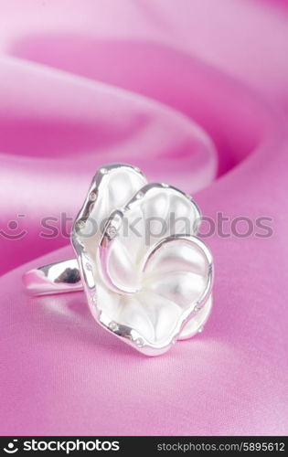 Jewellery ring on the satin background