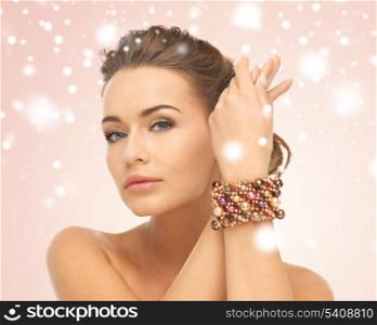 jewelry, luxury, bridal concept - beautiful woman wearing hand jewelry with beads
