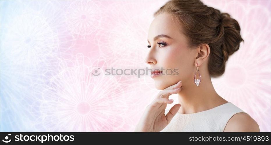 jewelry, luxury, wedding and people concept - smiling woman in white dress wearing pearl earring over rose quartz and serenity patterned background