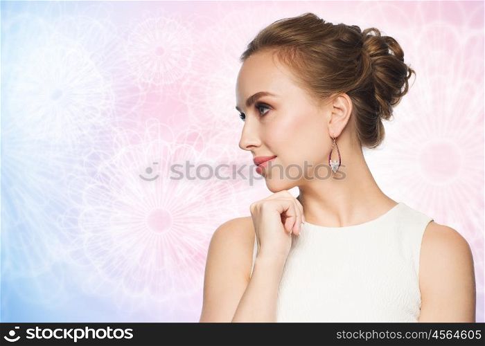 jewelry, luxury, wedding and people concept - smiling woman in white dress wearing pearl earrings over rose quartz and serenity pattern background
