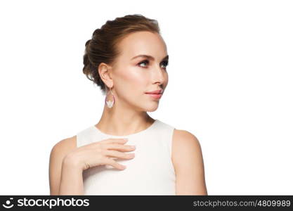 jewelry, luxury, wedding and people concept - smiling woman in white dress wearing pearl earrings over white background