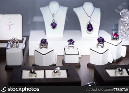 jewelry retail store showcase displaying white gold rings with amethysts and diamonds