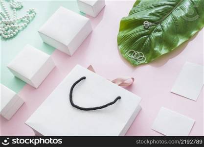 jewelry with white boxes leaf paper backdrop