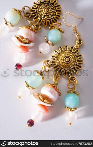 jewerly bijouterie earning with semiprecious at white background