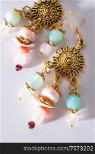 jewerly bijouterie earning with semiprecious at white background