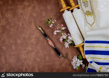 Jewish Orthodox holidays, during prayer items prayer shawl tallit with torah scroll in a synagogue. Jewish Orthodox holidays, during prayer items prayer shawl tallit with torah scroll