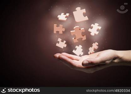 Jigsaw elements in palms. Human hand holding in palm puzzle elements