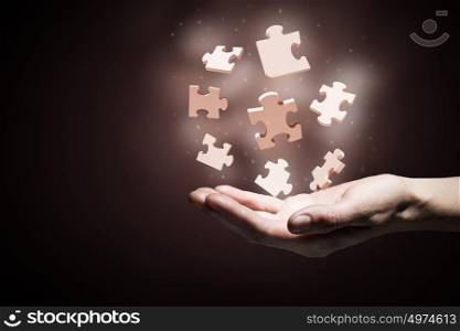 Jigsaw elements in palms. Human hand holding in palm puzzle elements