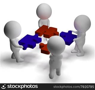 Jigsaw Pieces Being Joined Showing Teamwork And Assembling. Jigsaw Pieces Being Joined Shows Teamwork And Assembling