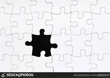 Jigsaw puzzle in white with a missing piece
