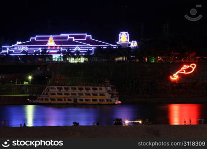JINHONG, CHINA - CIRCA JULY 2012 Restaurant and boat on the Mekong river