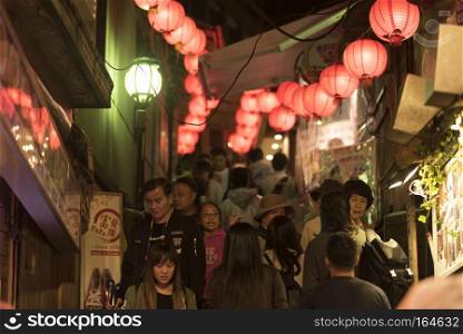 Jiufen,Taiwan - December 18 ,2016 : Tourists from all over the world walking and shopping in famous street night market in Jiufen. Jiufen is a mountain area in the Ruifang District of New Taipei City