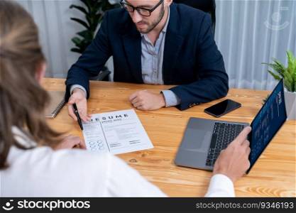 Job candidate engaging conversation with interviewer during job interview. Job applicant present work experience and qualification by digital resume on laptop and CV paper to HR manager. Entity. Job candidate engaging conversation with interviewer during job interview. Entity