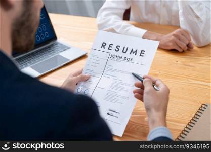 Job candidate engaging conversation with interviewer during job interview. Job applicant present work experience and qualification by digital resume on laptop and CV paper to HR manager. Entity. Job candidate engaging conversation with interviewer during job interview. Entity