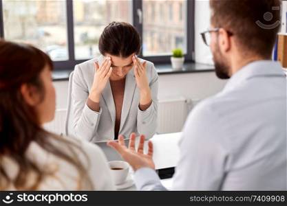 job, firing and employment concept - international team of recruiters having interview with female employee at office. recruiters having job interview with employee