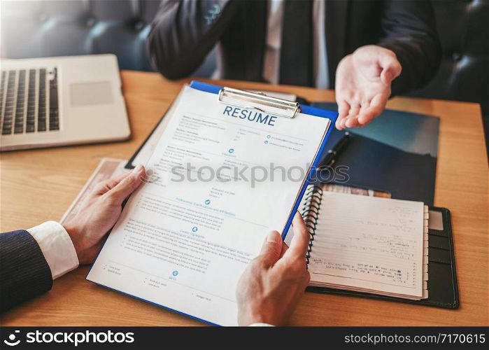Job interview concept , Senior manager reading a resume during a job interview employee young man meeting Applicant and recruitment