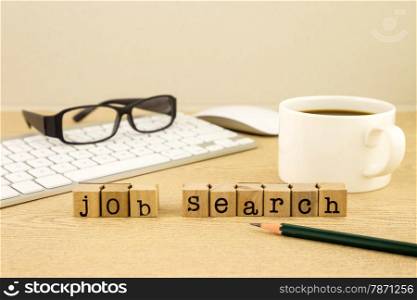 Job search word on rubber stamps place on table with a cup of coffee, keyboard and glassess, concept for employment