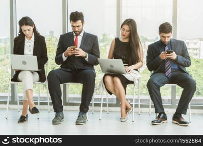 Job seekers and applicants waiting for interview on chairs in office. Job application and recruitment interview qualification concept.