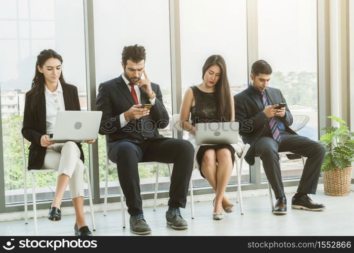 Job seekers and applicants waiting for interview on chairs in office. Job application and recruitment interview qualification concept.