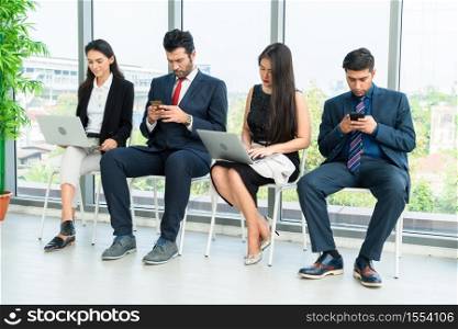 Job seekers and applicants waiting for interview on chairs in office. Job application and recruitment interview qualification concept.