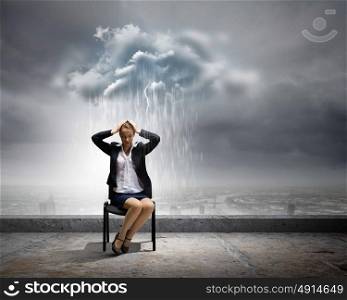 Job seeking. Image of young troubled businesswoman standing under rain