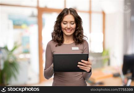 job, work and business concept - happy woman with tablet pc computer name tag over office background. happy woman with tablet pc at office